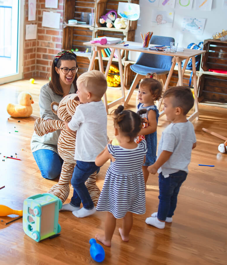 Group of kids with teacher in a classroom in a early learning centre