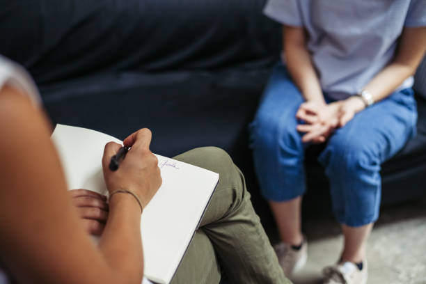 Psychotherapy session, woman talking to his psychologist in the studio